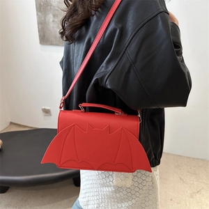 Gothic red bat-shaped crossbody bag for women with wings shown on a model