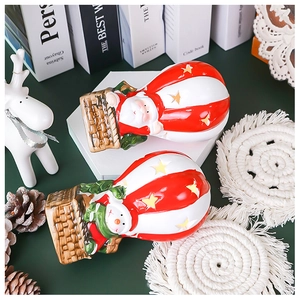 Detailed view of Santa and Snowman hot air balloon Christmas ornaments with LED star cutouts