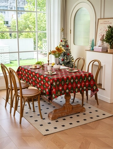Detailed close-up of a festive Christmas tablecloth with nutcracker and plaid patterns