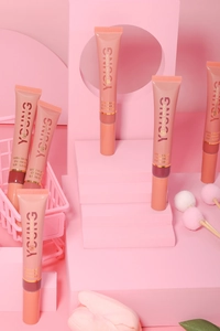 Close-up of five liquid lip gloss tubes with plush applicators and pink glossy finish
