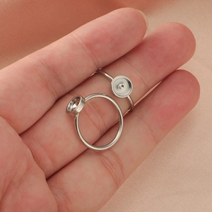 Pair of silver stainless steel DIY blank ring bases for jewelry setting on silk fabric
