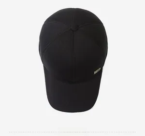 Top view of black corduroy baseball cap with thick texture and gold metal plaque detail