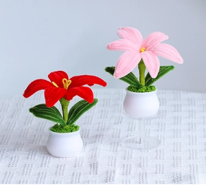 Detail view of handmade plush sunflower potted plants in red and pink colors