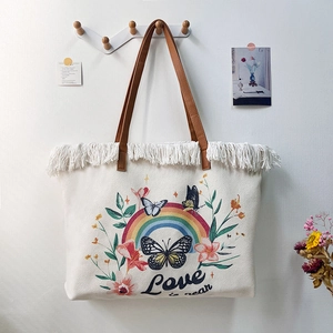 Bohemian canvas tote bag with white fringe trim and rainbow butterfly print design