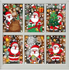 Christmas window stickers with Santa and snowflakes displayed on a white glass pane