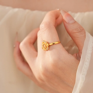 Detailed view of vintage gold flower ring with shimmering zircon petals and textured finish