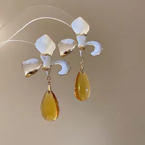 Elegant floral tassel earrings with white enamel lily and amber waterdrop pendants