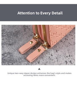 Detailed macro view of pink embossed leather wallet with golden metal zipper