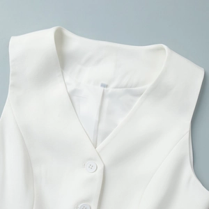 Detail of white suit vest featuring classic V-neckline with smooth inner lining and buttons
