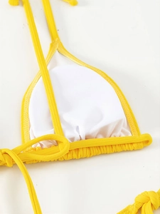 Detail of yellow ribbed bikini top showing white mesh lining and neat stitching texture