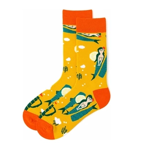 Detailed view of yellow cotton socks featuring mermaid and lemon illustration patterns