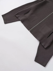 Detail of dark brown knit cardigan with metal zipper, ribbed cuffs, and side pockets