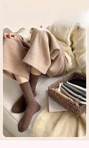 Detail of dark brown ribbed cotton socks showing premium knitted texture and elastic cuff