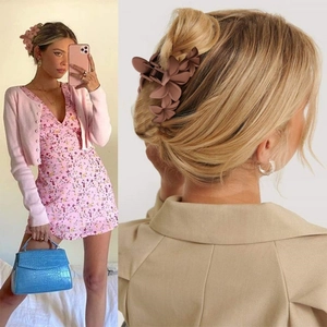 Matte brown floral hair claw clip shown in lifestyle setting and styling close-up
