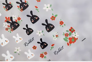 Detailed view of matte 5D nail art stickers featuring cute rabbits and floral patterns