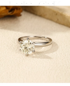 Macro shot of a 2-carat moissanite ring in classic six-prong setting on artistic background