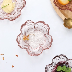 Pink cherry blossom shaped transparent glass sauce dish with petal edges and textures