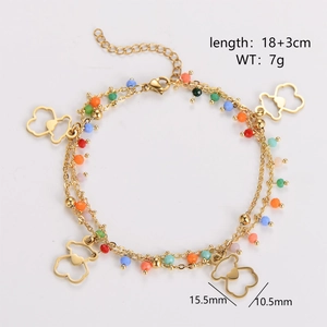 Detail view of double-layer gold chain bracelet with colorful beads and bear charms