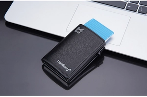 Detail of RFID blocking leather card holder with mechanical pop-up mechanism and brand logo