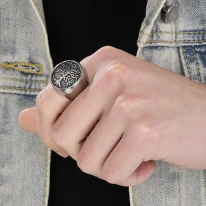 Macro detail of men's vintage stainless steel tree of life ring with a retro silver finish