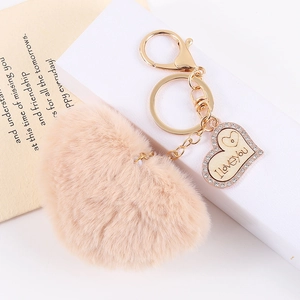 Detail of plush heart keychain with gold chain and engraved I Love You pendant