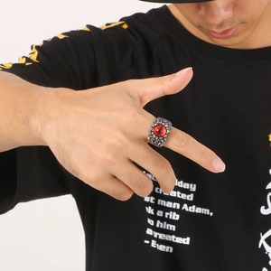 Gothic punk devil eye ring for men with red stone and skull feather textures in silver finish