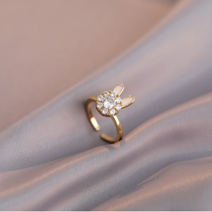 Adjustable golden bunny ring with white enamel and sparkling zircon on silk