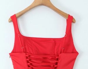 Detail of red sleeveless mermaid dress showing adjustable lace-up back design