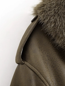 Detail of olive green suede jacket with detachable plush fur collar and shoulder strap
