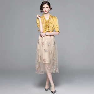 Elegant two-piece set featuring gold floral satin top and beige butterfly tulle skirt