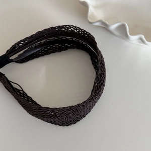 Detail view of woven headband texture with soft anti-slip inner lining and dark braiding