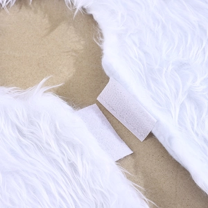 Macro shot of white plush faux fur Christmas tree skirt with Velcro closure detail