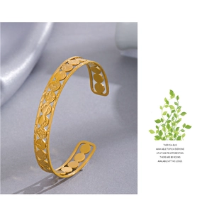 Detail of 14K gold plated stainless steel cuff bangle featuring open circular hollow design