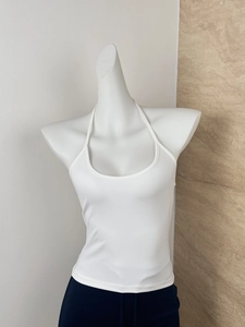 Detail of white halter neck slim fit tank top on a mannequin with open back design