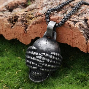Gothic skull pendant necklace with hands covering eyes in antique silver on mossy bark