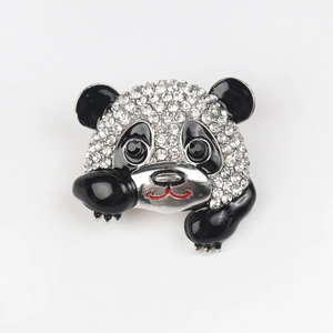 Detailed view of silver panda brooch with sparkling rhinestones and black enamel accents