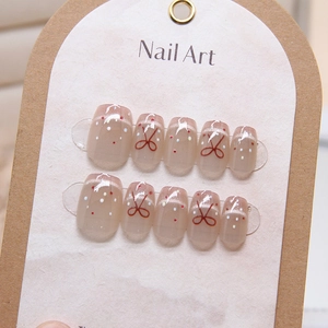 French cat-eye press-on nails with red bow and colorful polka dots on 10pc squoval tips