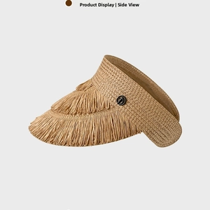 Detail of khaki straw sun visor featuring layered fringe edges and a metal D-logo emblem