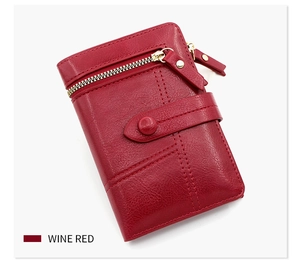 Detailed view of wine red PU leather wallet with lychee texture and gold zipper buckle