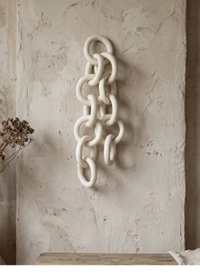 Close-up of matte white ceramic chain ring with minimalist Wabi-sabi texture for decor