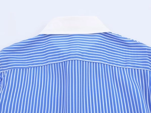 Detail of white contrast collar and stitching on blue and white striped shirt