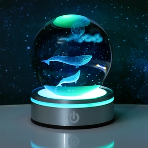 3D laser engraved crystal ball with whale and moon on a blue LED metal base