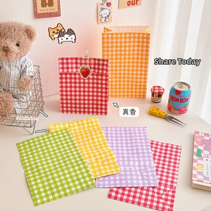 Detailed view of foldable checkered kraft paper gift bags in five vibrant assorted colors