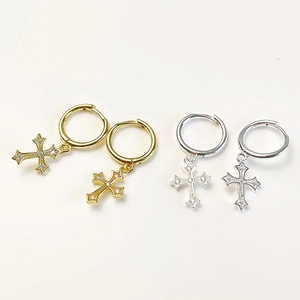 Close-up of gold and silver S925 cross hoop earrings with inlaid crystals on white background