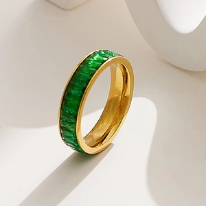 Detail of gold-plated eternity ring featuring emerald green rectangular cubic zirconia stones