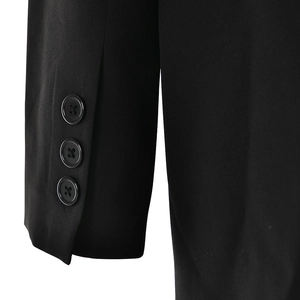 Detailed close-up of high-quality fabric texture and three black buttons on the blazer sleeve