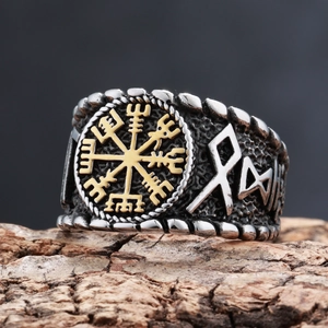 Silver Viking compass ring with golden runes on rustic bark background for men