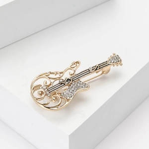 Exquisite gold alloy guitar brooch with white rhinestones on white geometric stand