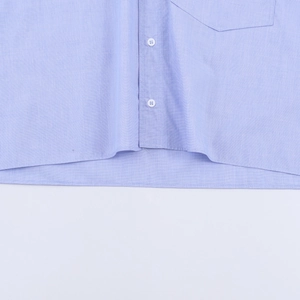Detail of light blue cotton striped shirt featuring white buttons and a clean front placket
