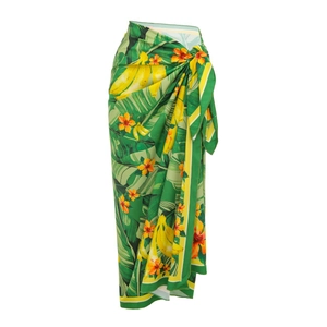 Detail of tropical green leaf print wrap sarong skirt with side tie waist design